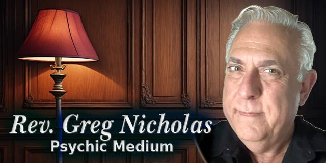 Rev. Greg Nicholas, psychic medium, pictured beside a warm burgundy lamp in a mahogany-paneled Victorian interior.