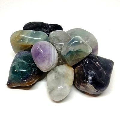 Tumbled fluorite stones in shades of green and purple for September’s gemstone of the month.
