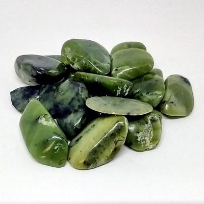 Polished nephrite jade stone on white background
